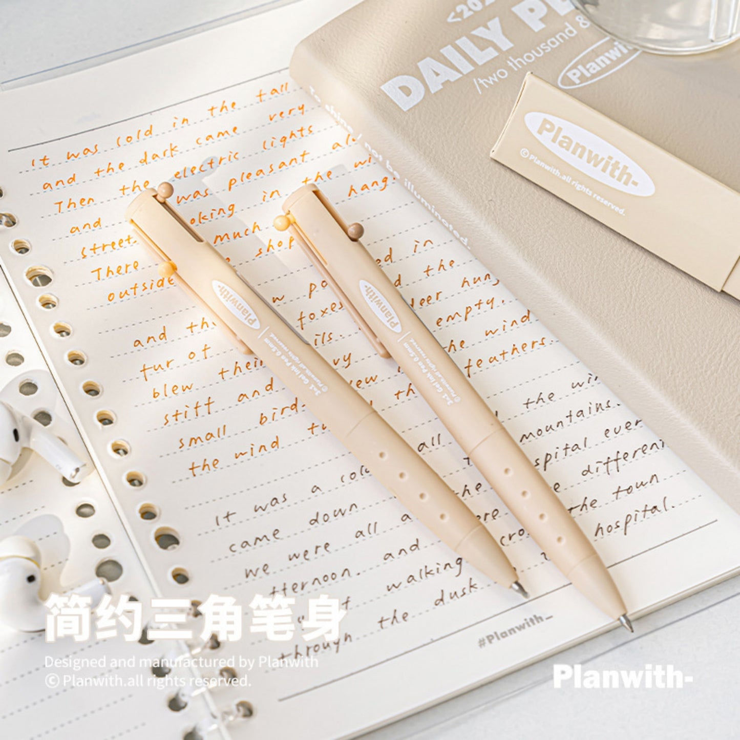 Close up of Triangular Beige Barrel Multicolor Gel Ink Pen on the Notebook