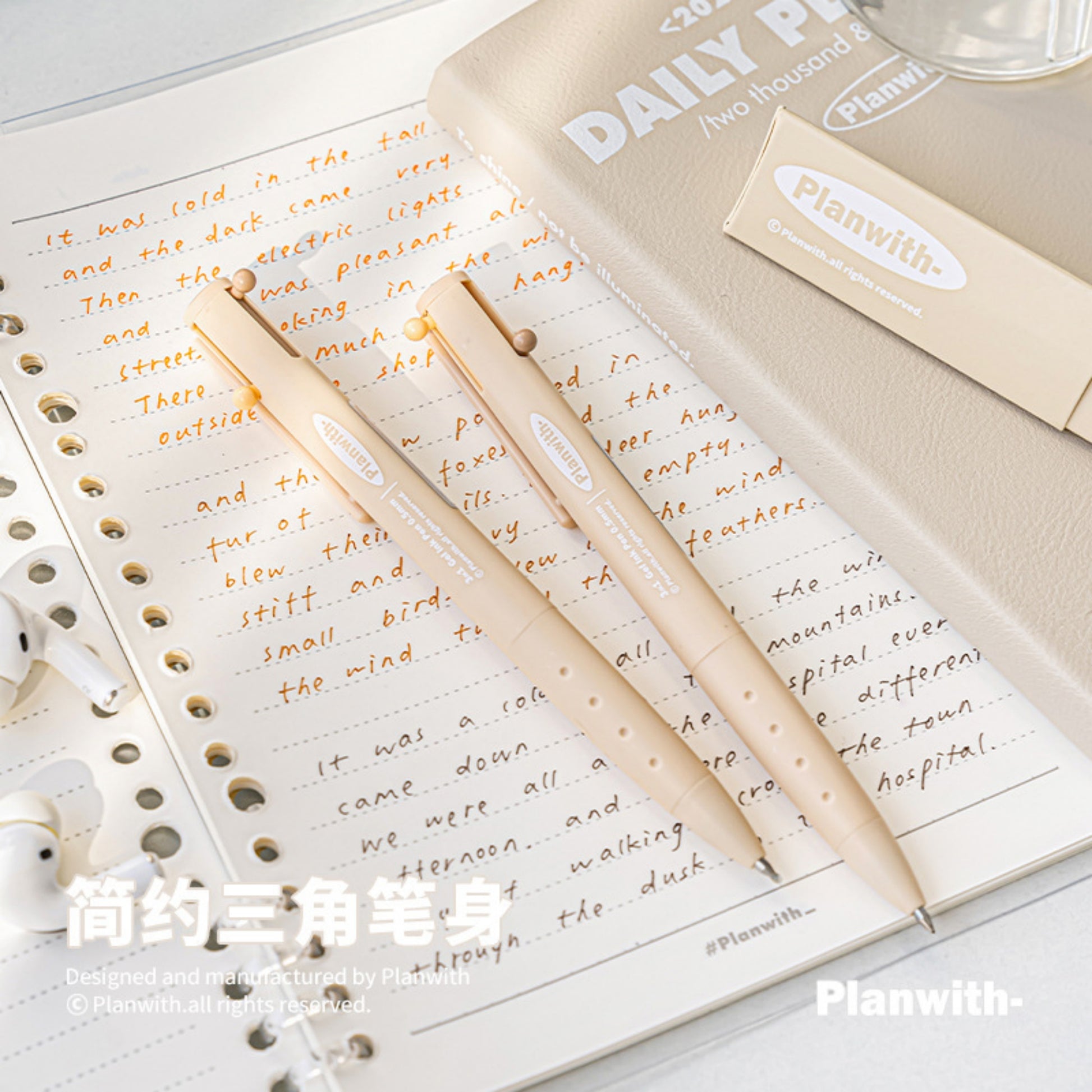 Close up of Triangular Beige Barrel Multicolor Gel Ink Pen on the Notebook
