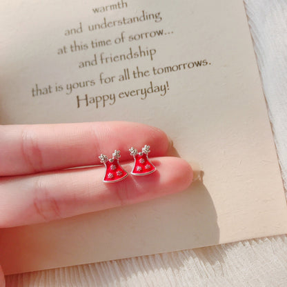 A hand holding Christmas Red Bell Earrings with Cute Antlers