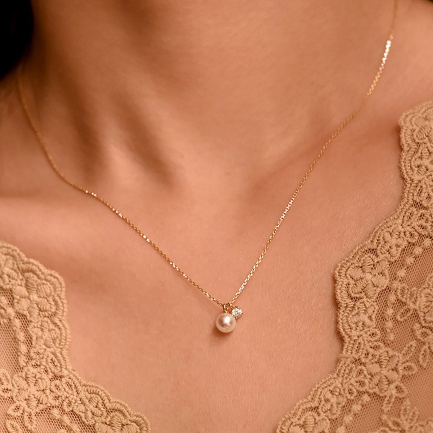 Women wearing the Mother of Pearl Cubic Zirconia Necklace with Gold Chain and 7mm Pearl 