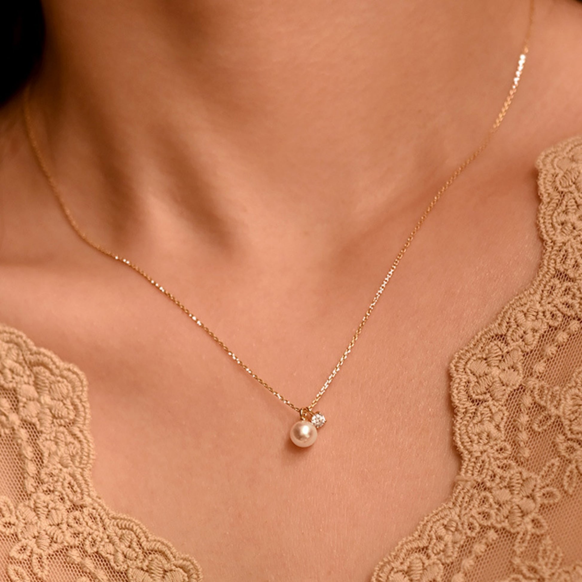 Women wearing the Mother of Pearl Cubic Zirconia Necklace with Gold Chain and 7mm Pearl 