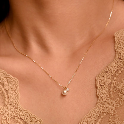 Women wearing the Mother of Pearl Cubic Zirconia Necklace with Gold Chain and 7mm Pearl 