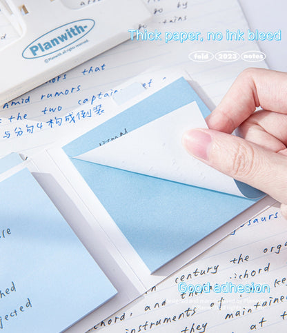 A person peel one blue piece from Rosy Posy sticky note pad thick paper