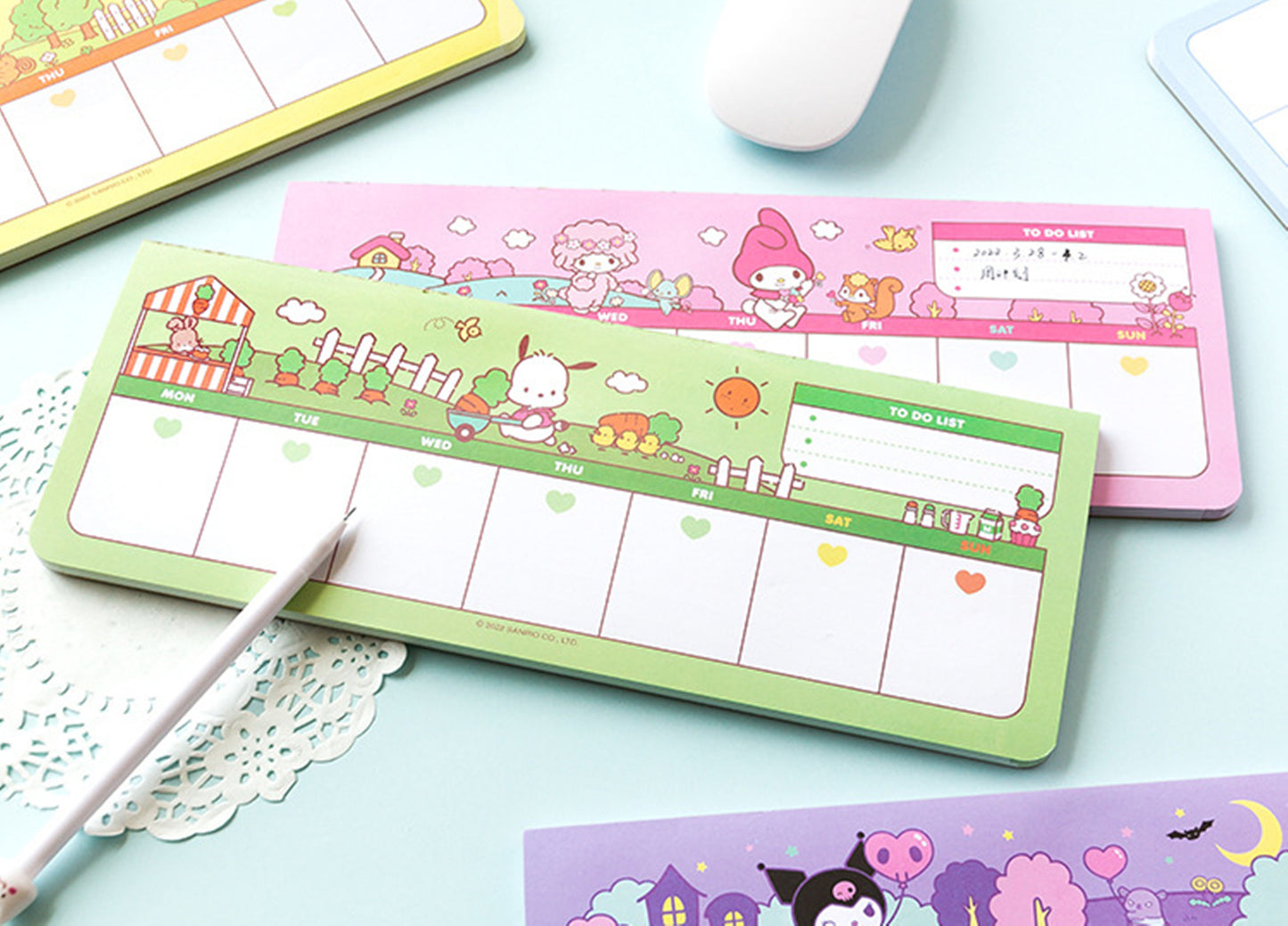 Sanrio Weekly Desk Planner Pad My Melody Pochacco Pink Green Color on the Blue Table