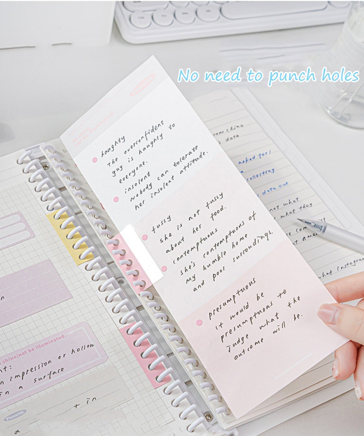 Hand placing a pink extension sticker on a loose-leaf binder page with notes, showing how it extends and adds writing space.