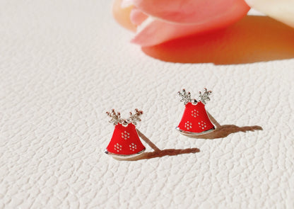 Red bell earrings with Adorable antlers displayed on a white table